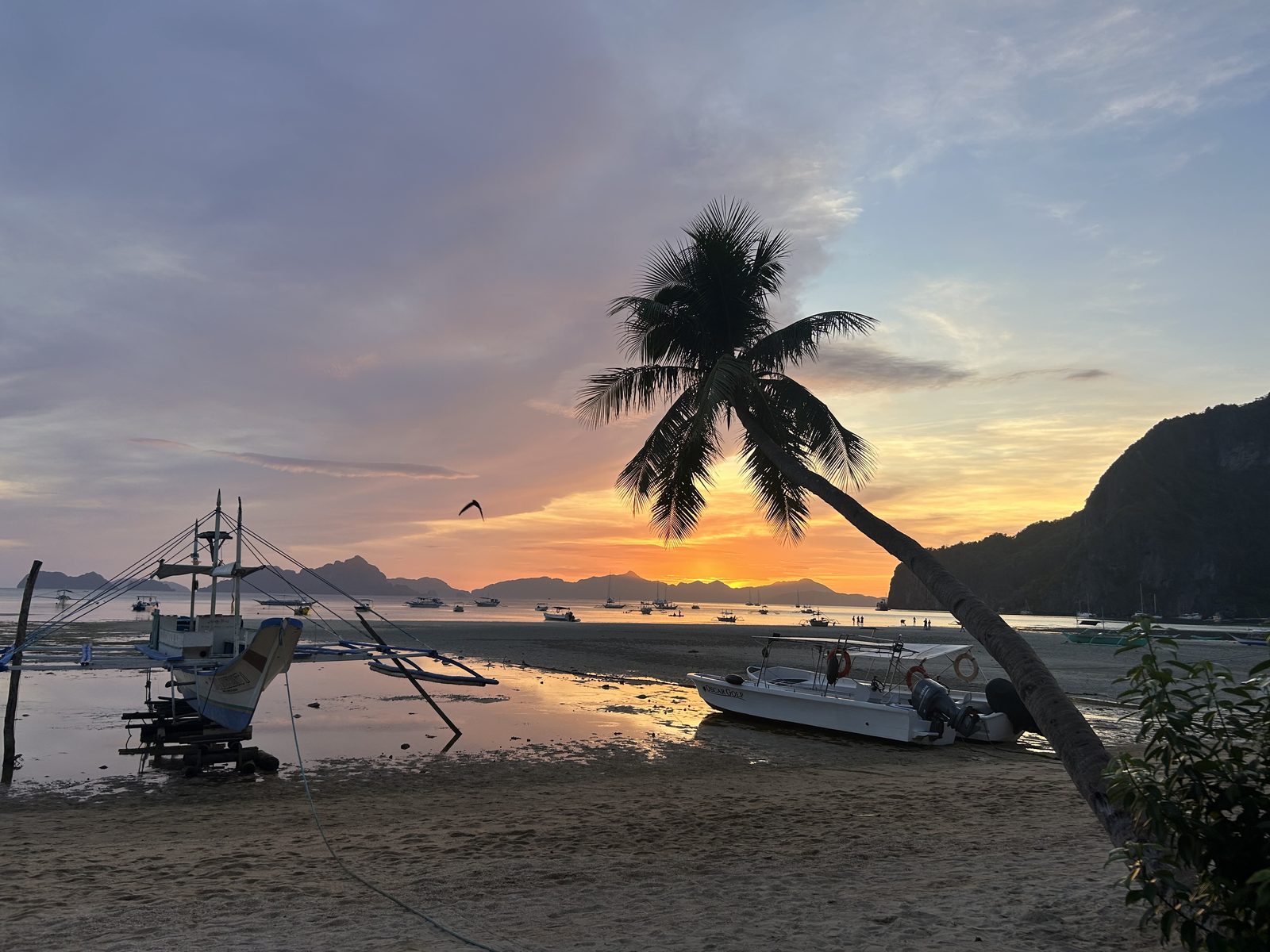 Low tide turning gold, the bangka boats settling in for the night.