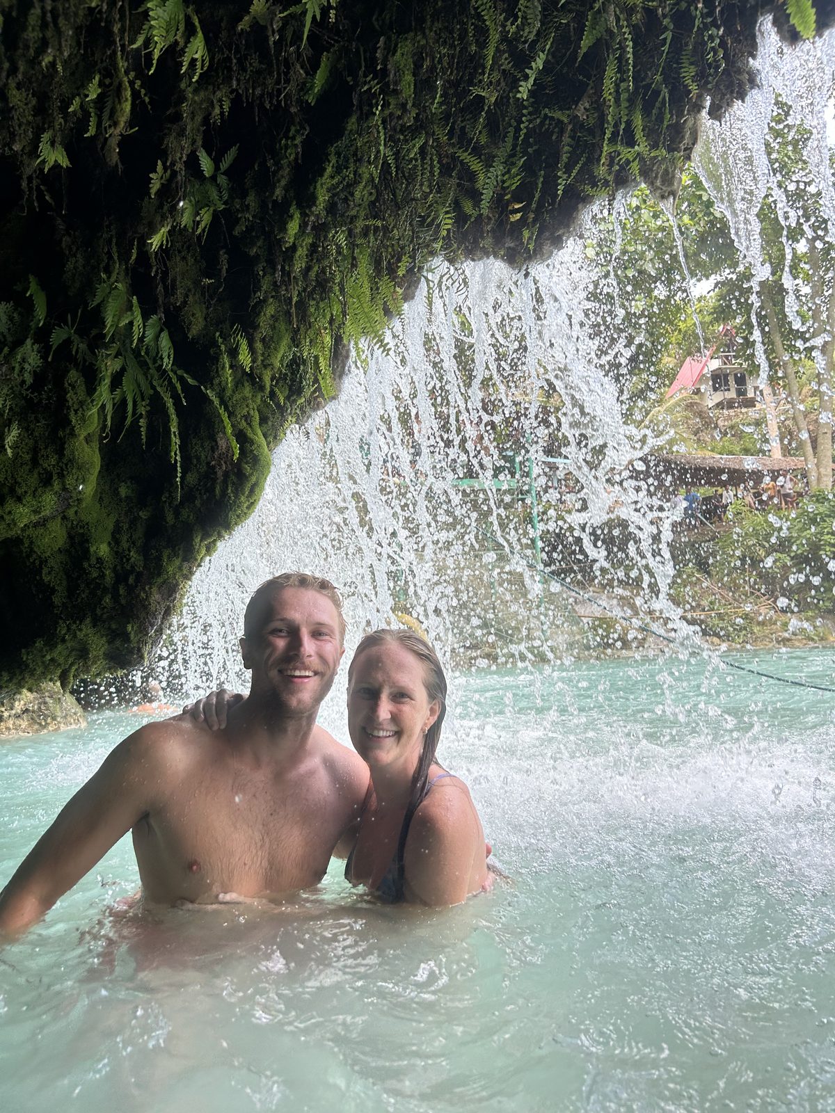 Swinging into the turquoise pool below the falls.