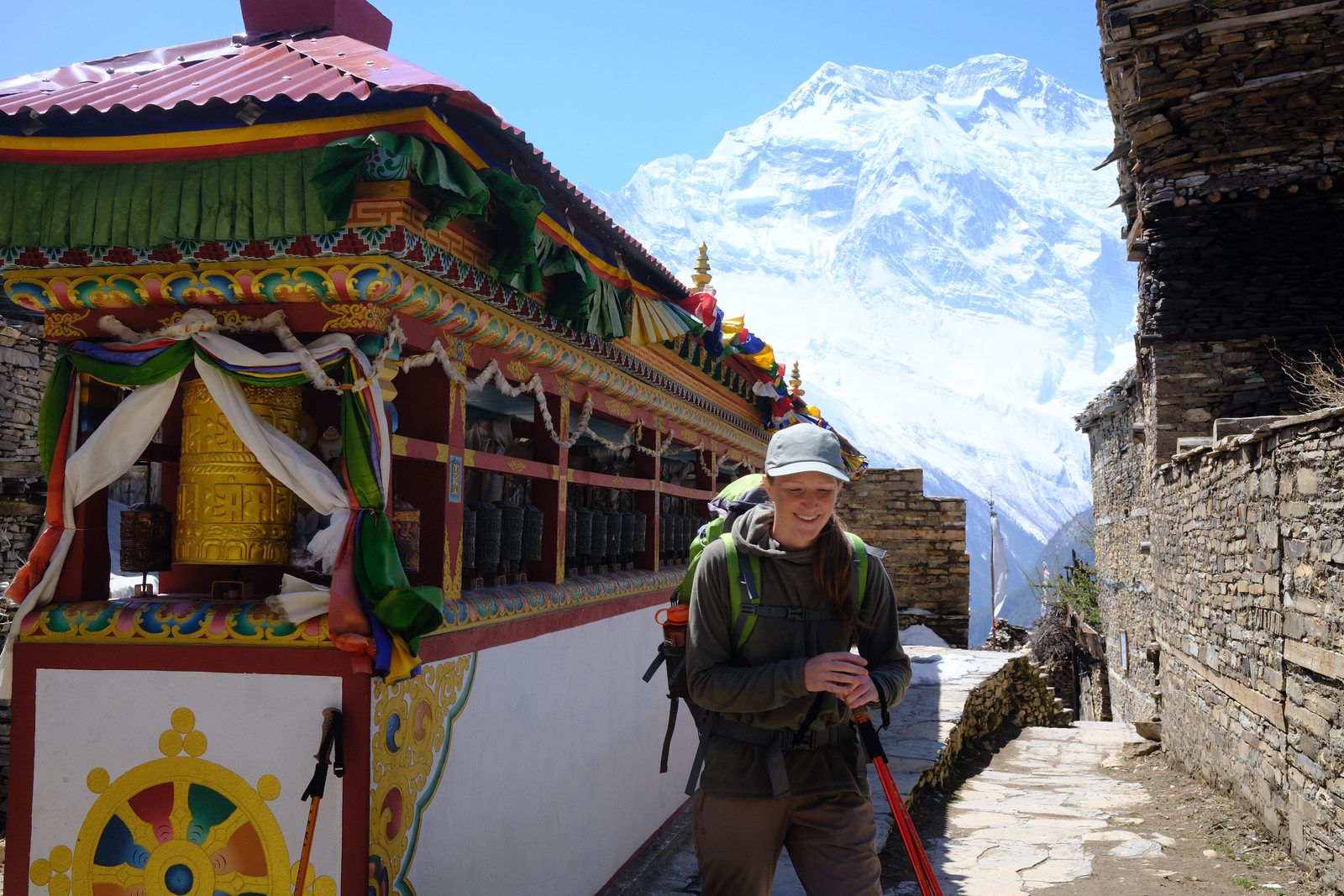 Painted prayer wheels beneath the peaks.