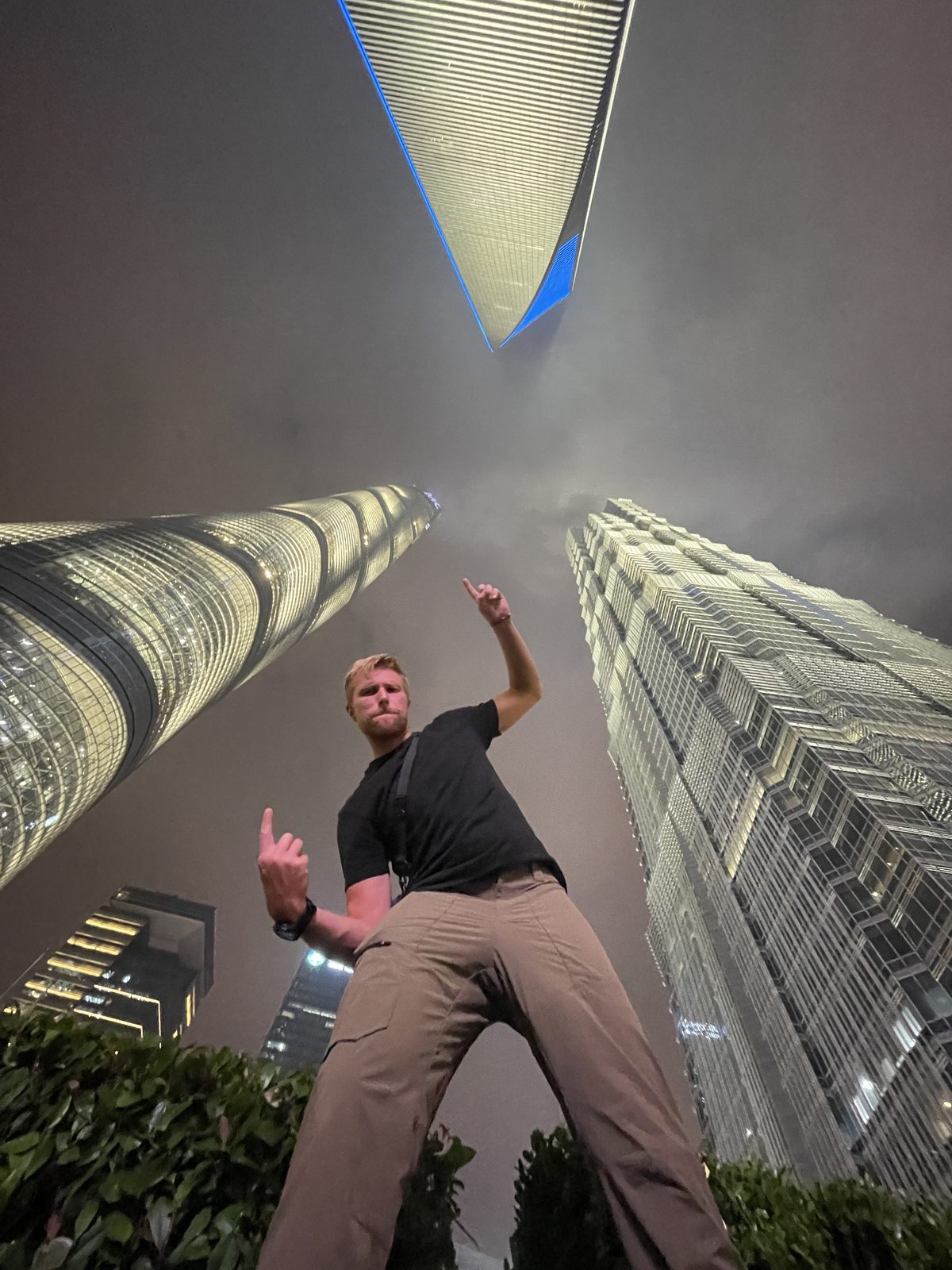 Looking straight up at the Lujiazui towers — Shanghai after dark.