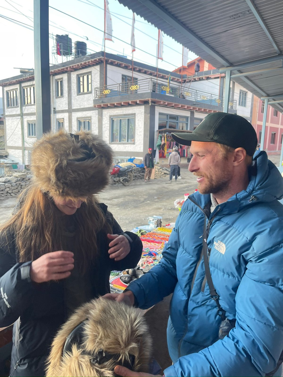 Trying on the fur hats in Muktinath