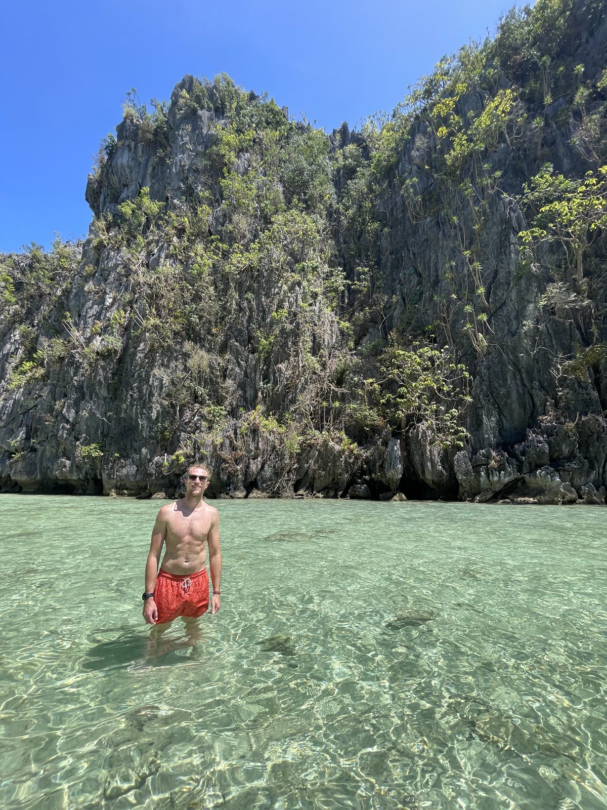 Wading out under the limestone cliffs.