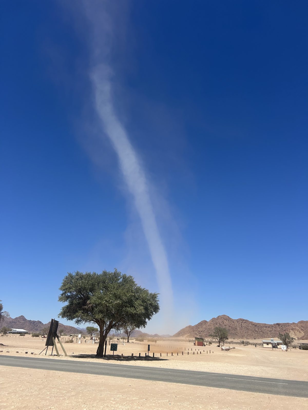A dust devil twisting across the plain.
